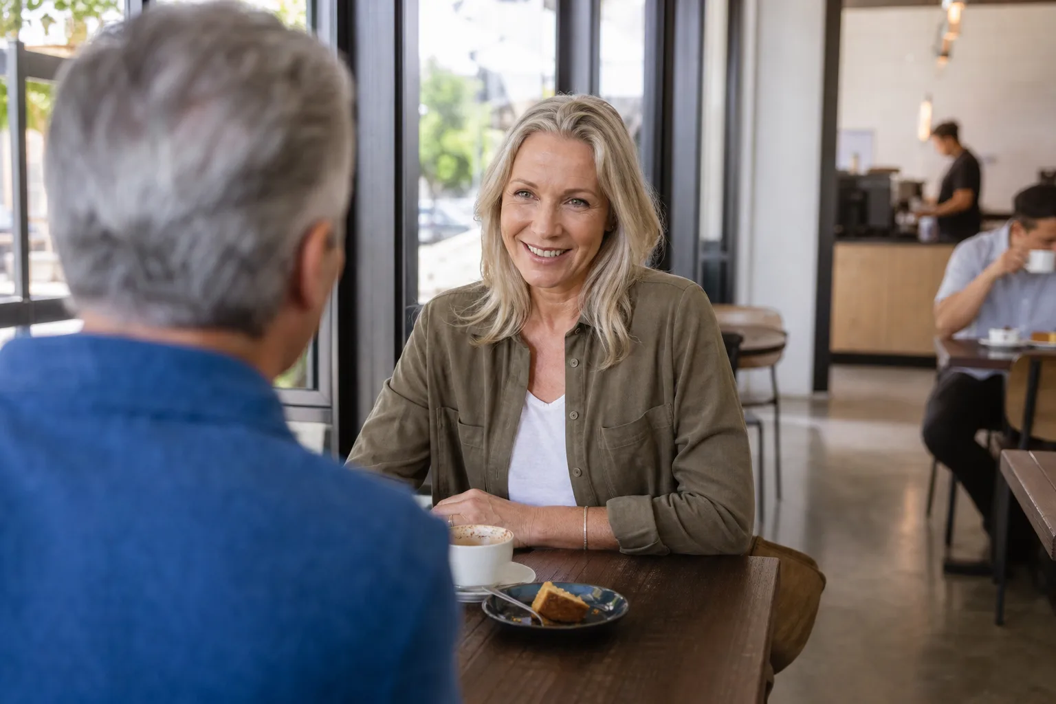 Two people over 50 talking over coffee in Bristol